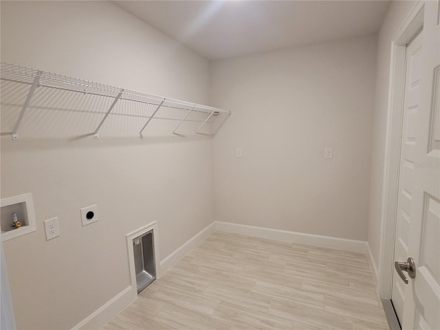 laundry room featuring light wood-type flooring, hookup for a washing machine, and electric dryer hookup