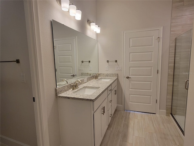 bathroom with an enclosed shower and vanity