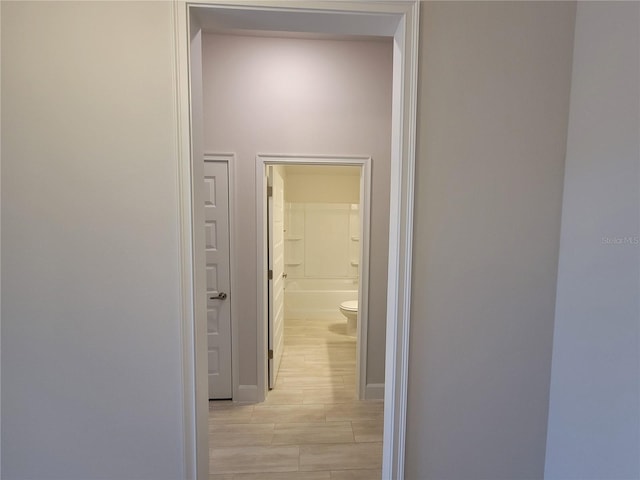 hallway with light wood-type flooring