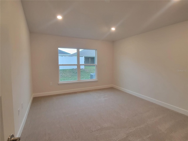 unfurnished room with light carpet