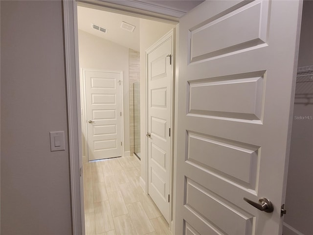 corridor featuring lofted ceiling and light wood-type flooring