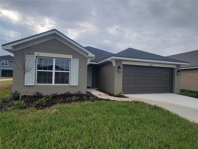 ranch-style house with a garage and a front lawn