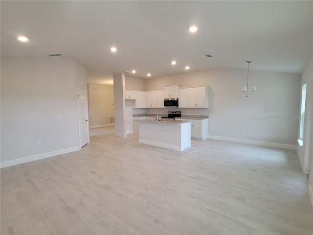 kitchen with white cabinets, light stone counters, light hardwood / wood-style flooring, a kitchen island with sink, and appliances with stainless steel finishes