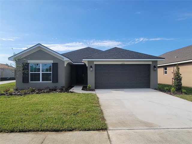ranch-style home featuring stucco siding, driveway, a garage, and a front yard