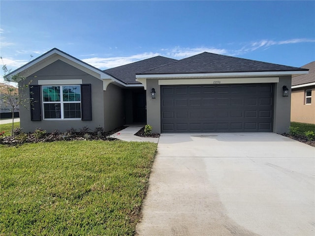 ranch-style home featuring an attached garage, concrete driveway, a front lawn, stucco siding, and a shingled roof