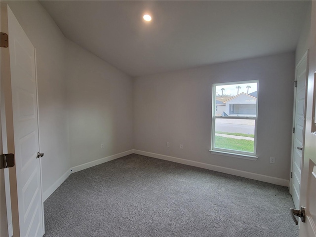 carpeted empty room featuring baseboards and recessed lighting