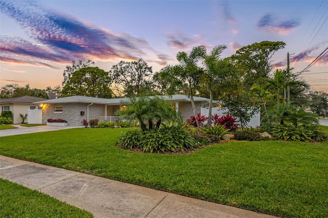 ranch-style house with a lawn