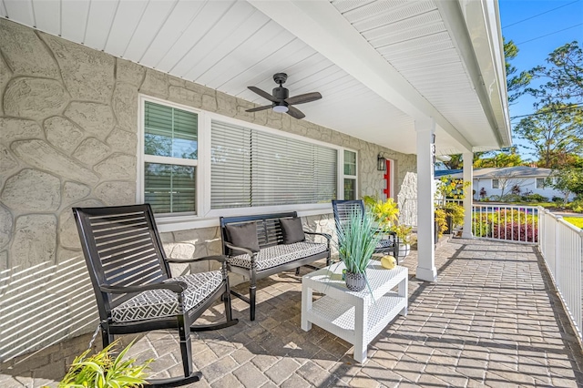 view of patio / terrace with ceiling fan and a porch