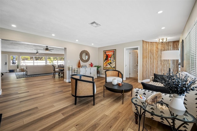 living room with ceiling fan and light wood-type flooring