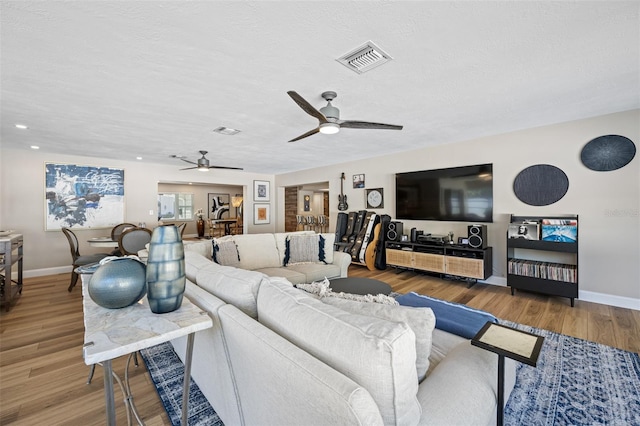 living room with wood-type flooring and a textured ceiling