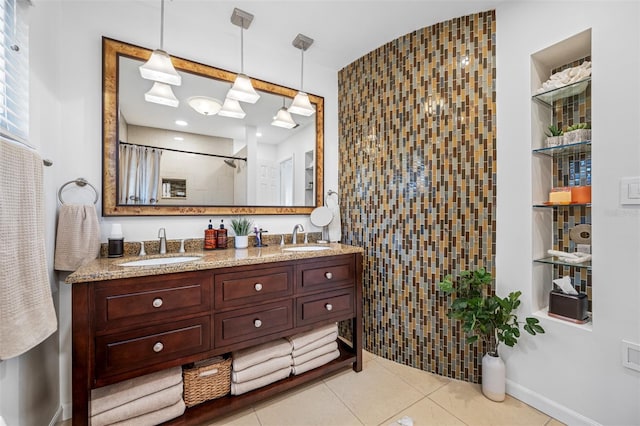 bathroom with a shower, vanity, and tile patterned flooring