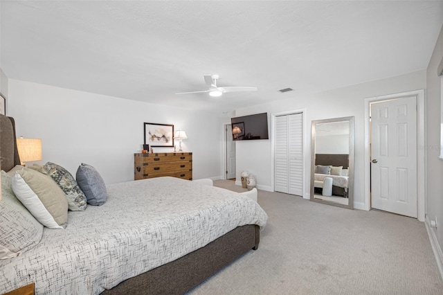 bedroom with ceiling fan, a closet, and carpet