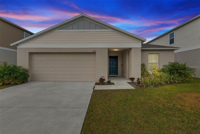 view of front facade featuring a garage and a yard