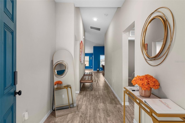 hallway with light hardwood / wood-style flooring