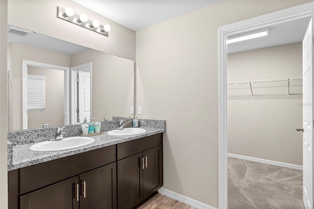 bathroom with vanity and a textured ceiling