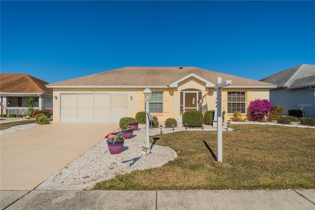 ranch-style home with roof with shingles, stucco siding, concrete driveway, a front yard, and a garage