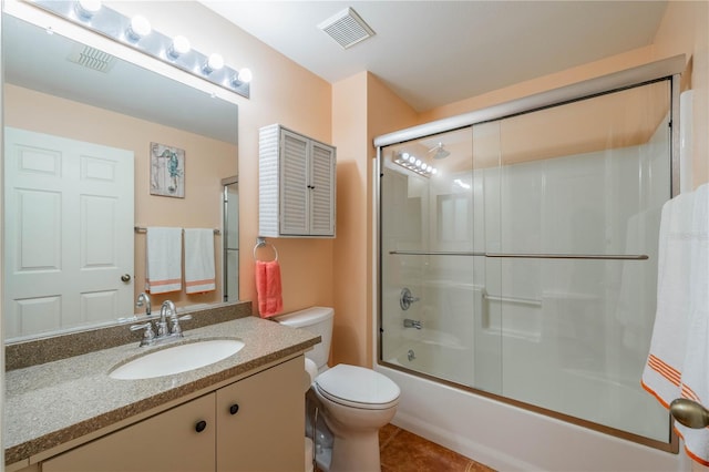 full bath featuring bath / shower combo with glass door, visible vents, toilet, vanity, and tile patterned flooring