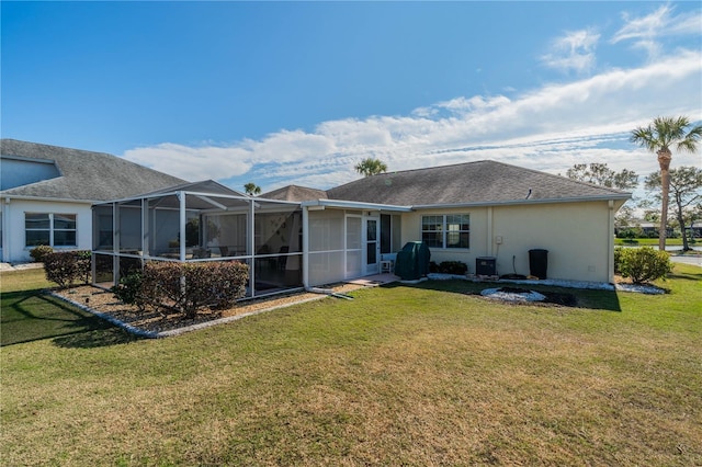 rear view of property with central AC, a lawn, and stucco siding