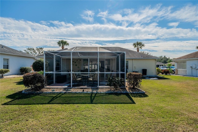 back of house with a lawn, a patio area, a lanai, and stucco siding