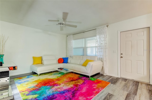 living room with ceiling fan and light wood-type flooring