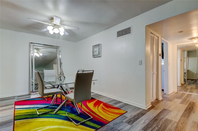 dining room with ceiling fan and wood-type flooring