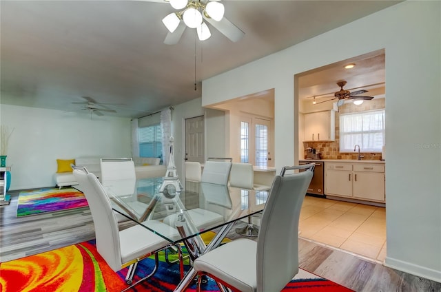 dining room featuring sink and light tile patterned flooring