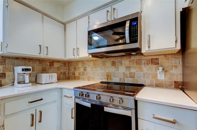 kitchen featuring backsplash, white cabinets, and stainless steel appliances