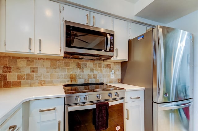 kitchen featuring decorative backsplash, white cabinetry, and stainless steel appliances