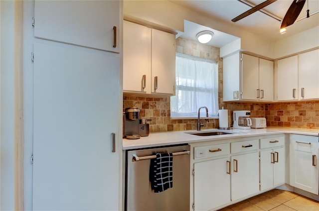 kitchen with stainless steel dishwasher, ceiling fan, white cabinets, and sink