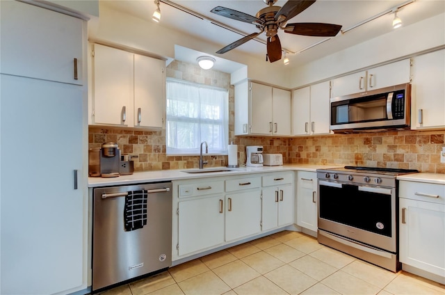 kitchen featuring ceiling fan, white cabinets, and stainless steel appliances