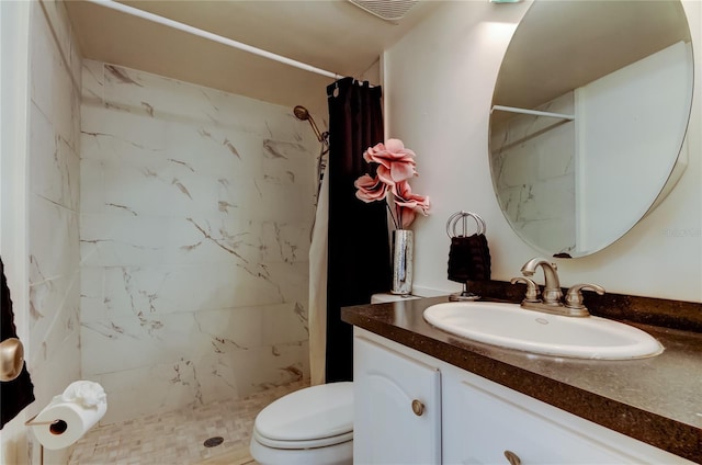 bathroom featuring vanity, toilet, and walk in shower