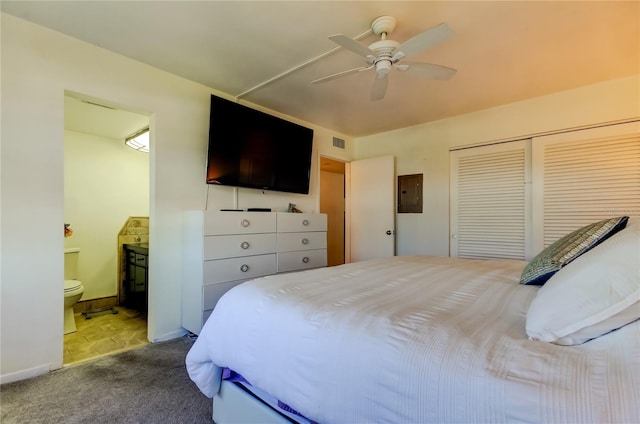 bedroom with carpet, ensuite bath, ceiling fan, electric panel, and a closet