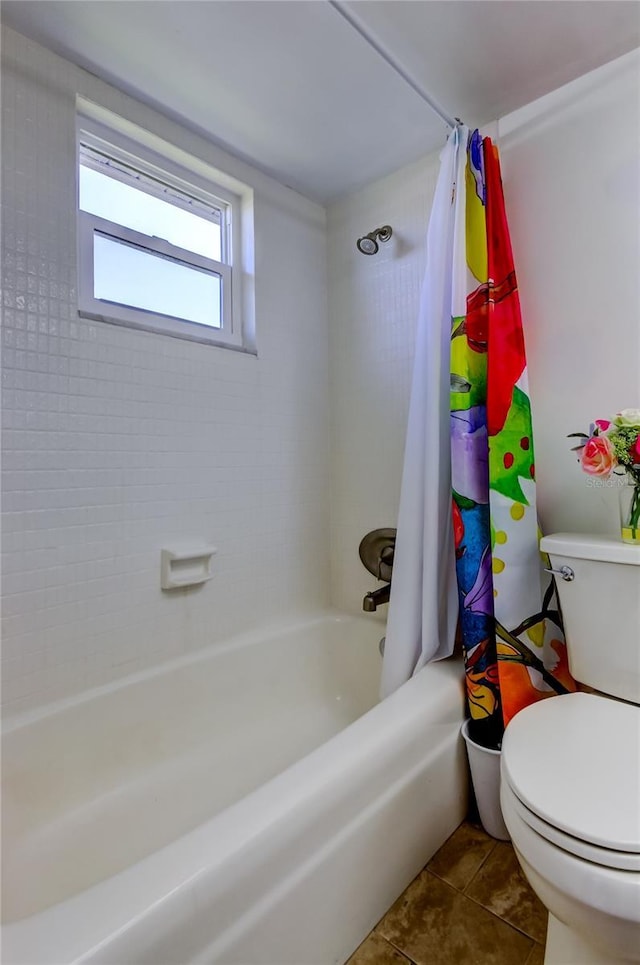 bathroom with tile patterned flooring, shower / bathtub combination with curtain, and toilet