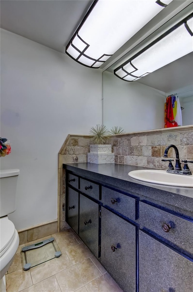 bathroom featuring tile patterned floors, decorative backsplash, vanity, and toilet