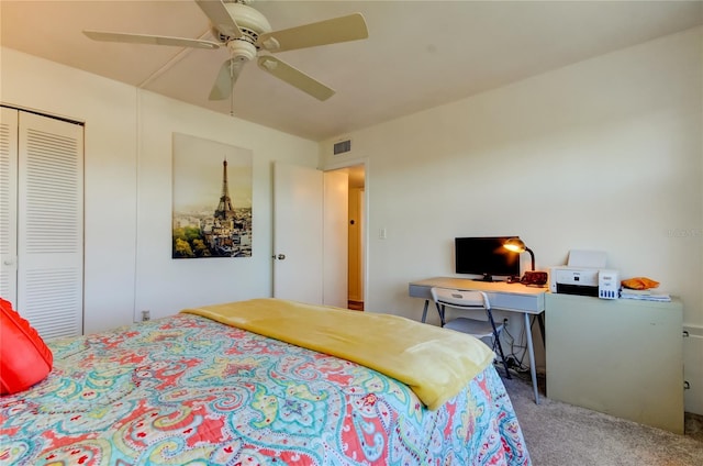 bedroom featuring ceiling fan, light colored carpet, and a closet