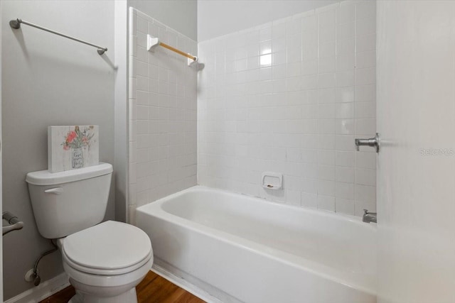 bathroom with toilet, washtub / shower combination, and wood-type flooring