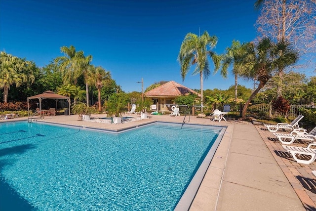 view of swimming pool with a patio and a gazebo