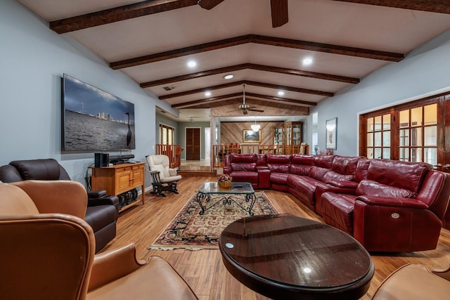 living room with light wood-type flooring, ceiling fan, and vaulted ceiling with beams