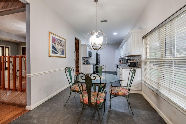 dining space featuring a notable chandelier