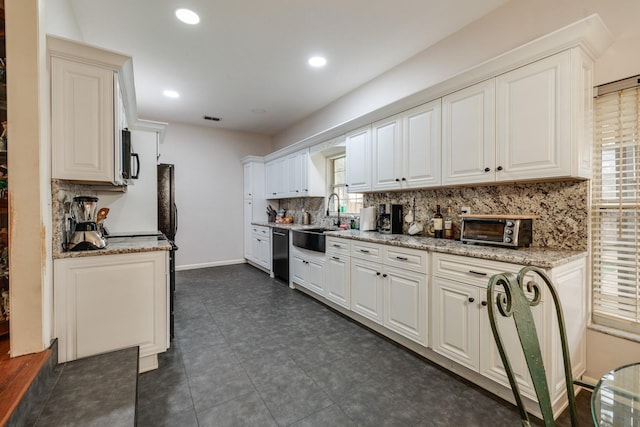 kitchen featuring black appliances, white cabinetry, light stone countertops, and sink