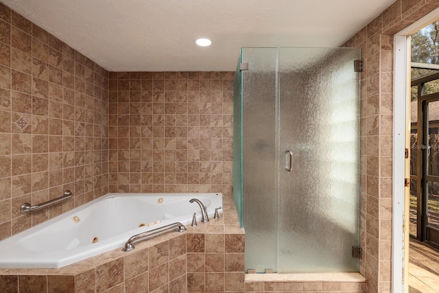 bathroom with tile walls and independent shower and bath