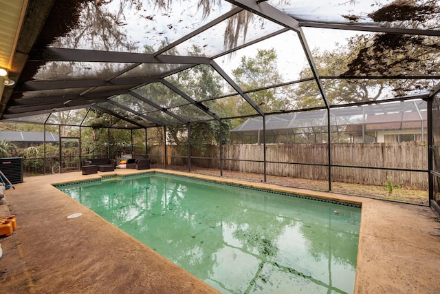 view of swimming pool featuring an outdoor living space, a patio area, a lanai, and central AC