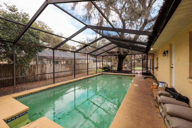 view of swimming pool with glass enclosure