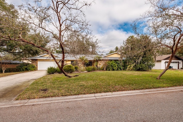 obstructed view of property featuring a garage and a front lawn