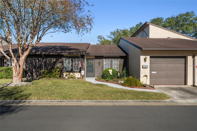 ranch-style house featuring a front yard and a garage