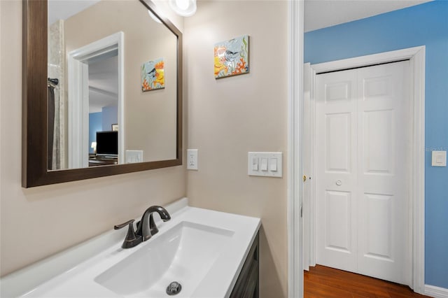 bathroom featuring hardwood / wood-style floors and vanity