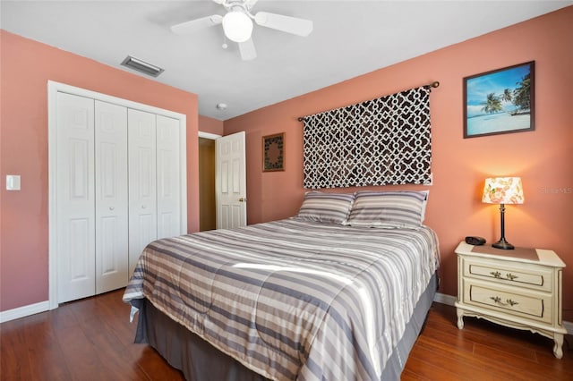 bedroom featuring ceiling fan, a closet, and dark wood-type flooring