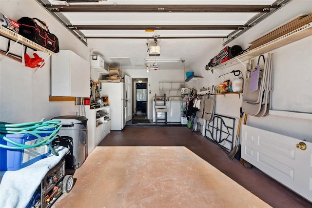 garage featuring white fridge, independent washer and dryer, and a garage door opener