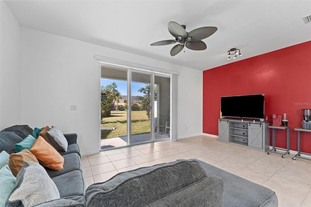 tiled living room featuring ceiling fan