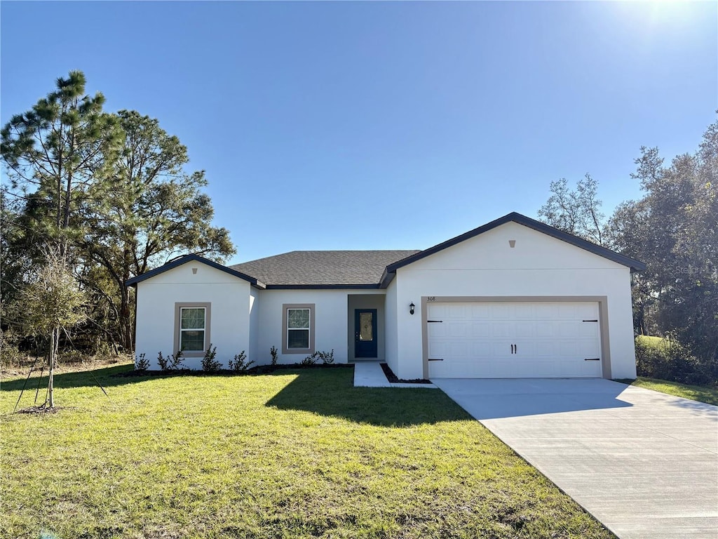 ranch-style home with a front yard and a garage